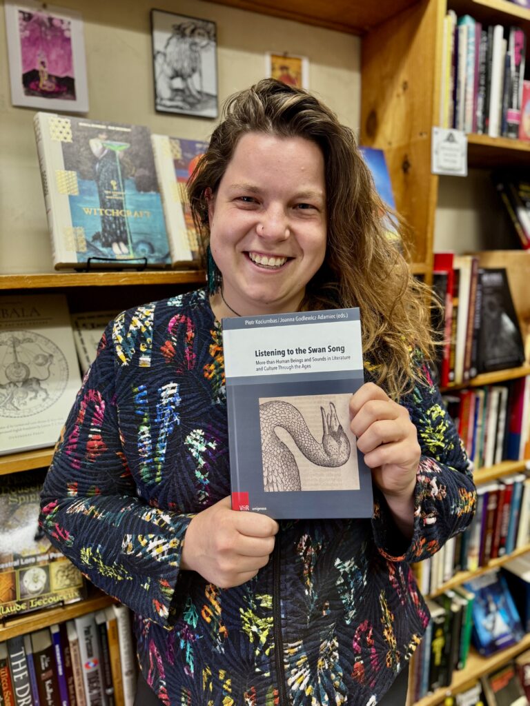 Marie Comuzzo holding a book titled Listening to Swan Song