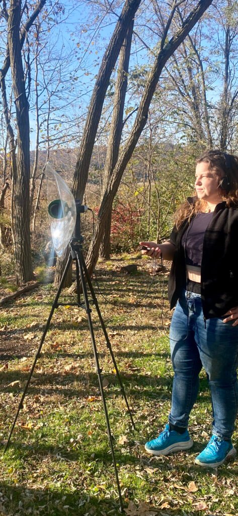 Marie Comuzzo listening and recording in the forest